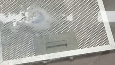 Rangehood filters being cleaned with denture tablets