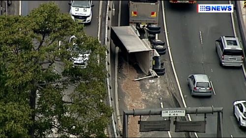 Disqualified driver charged after Cahill Expressway truck rollover chaos