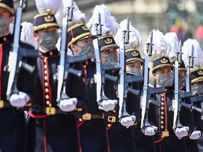 Belgium's Crown Princess Elisabeth, fourth right, marches past the Royal tribune with cadets of the military school during the National Day parade in Brussels, Wednesday, July 21, 2021. Belgium celebrates its National Day on Wednesday in a scaled down version due to coronavirus, COVID-19 measures. (Laurie Dieffembacq, Pool Photo via AP)