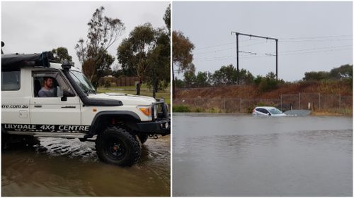 A four-wheel-drive was used to free the bogged silver Ford.