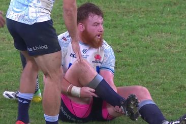 Harry Johnson-Holmes clutches his leg after falling in the Waratahs vs Brumbies match.