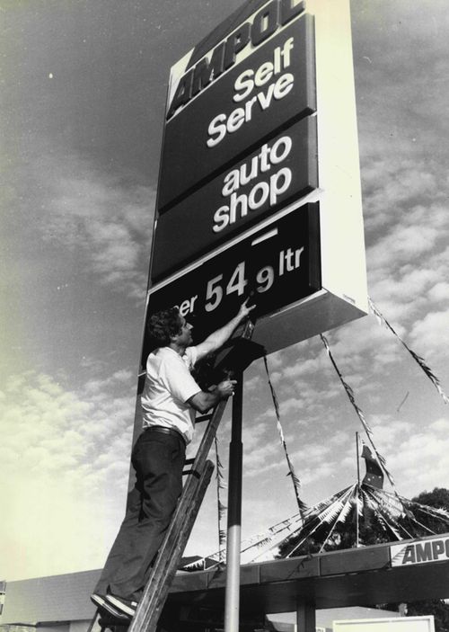 The manager of the Ampol Service Station on Anzac Parade in Sydney's east changes the petrol prices on his sign, in 1987.