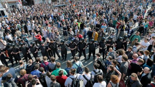 Russian riot police faces a huge crowd of participants of an unauthorized liberal opposition rally, called by their leader Alexei Navalny, prior to the official inauguration of president Putin. (EPA)