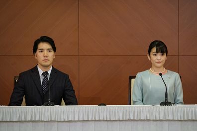 TOKYO, JAPAN - OCTOBER 26: Princess Mako (R), the elder daughter of Prince Akishino and Princess Kiko, and her husband Kei Komuro, a university friend of Princess Mako, pose during a press conference to announce their wedding at Grand Arc Hotel on October 26, 2021 in Tokyo, Japan. Princess Mako married Kei Komuro today at a registry office following a relationship beset with controversy following the revelation that Mr Komuros mother was embroiled in a financial dispute with a former fianc. Fol