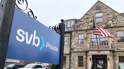 The vehicles are parked in front of a Silicon Valley Bank branch.