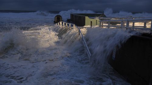 The five-six metre swell pummelled Newcastle's famed Ocean baths, bringing sightseers to witness the event and to surrounding beaches , including Bar Beach where the Cools Hill Surf Club took a battering.