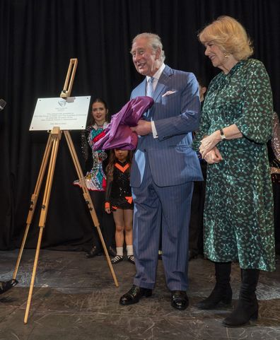 Prince Charles unveils a plaque during a visit with Camilla, the Duchess of Cornwall to the Irish Cultural Centre to celebrate the Centre's 25th anniversary in the run-up to St Patrick's Day
