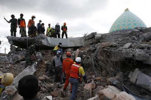 There were reports of dozens of people who had been killed at the mosque, which was completely flattened by the quake. Picture: AP.