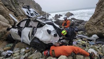 This photo provided by the San Mateo County Sheriff&#x27;s Office shows emergency personnel responding to a vehicle over the side of Highway 1 on Sunday, Jan. 1, 2023, in San Mateo County, Calif.