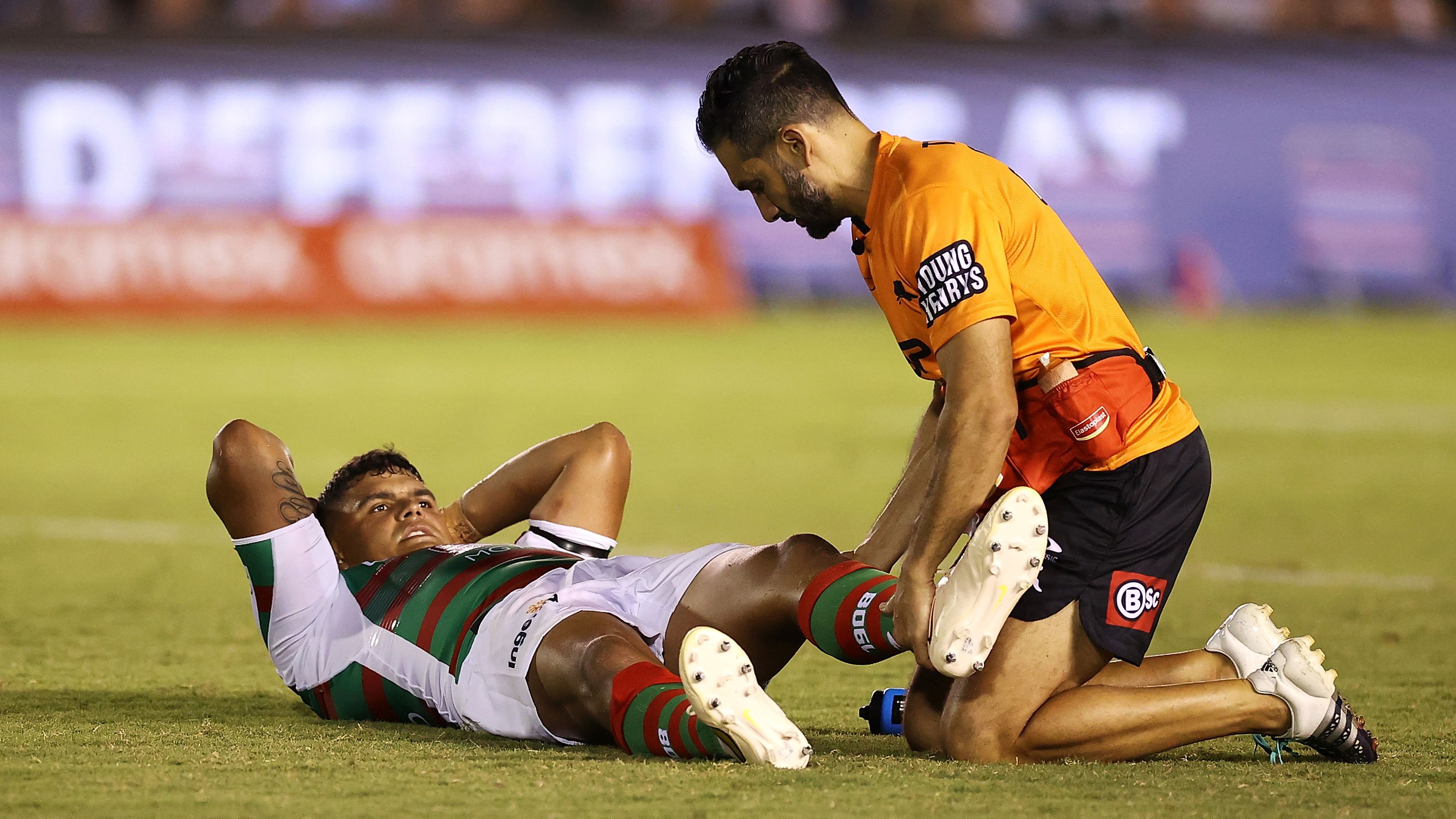 Latrell Mitchell of the Rabbitohs receives attention from the trainer during the round one NRL match between Cronulla Sharks and South Sydney Rabbitohs at BlueBet Stadium on March 04, 2023 in Cronulla, Australia. (Photo by Mark Kolbe/Getty Images)