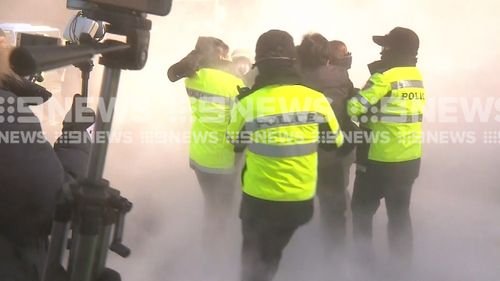 At least one protester was arrested. (9NEWS)