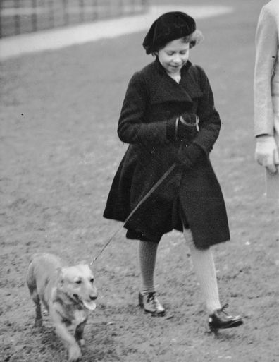 FILE - Princess Elizabeth takes her pet dog for a walk in Hyde Park, London, on Feb. 26. 1936. It's widely known that Elizabeth loved corgi dogs, Princess Diana reportedly called the animals the queen's "moving carpet" because they accompanied her everywhere.  (AP Photo, File)