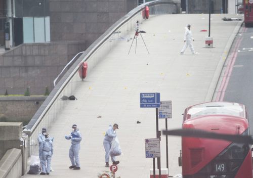 Forensic officers search for evidence across London Bridge the morning after the terror attack at London Bridge and Borough Market, central London.