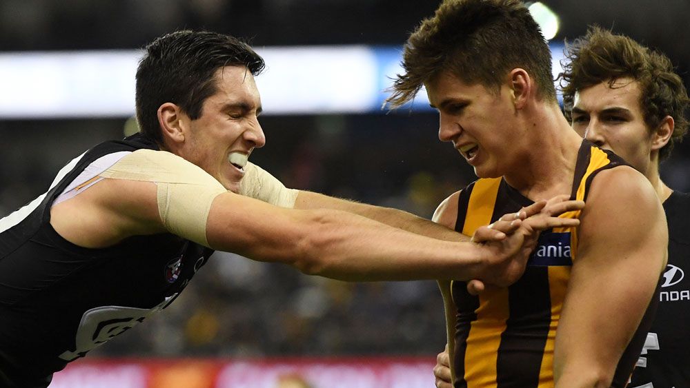 Jacob Weitering and Daniel Howe get to know one another during the clash between Carlton and Hawthorn. (AAP)