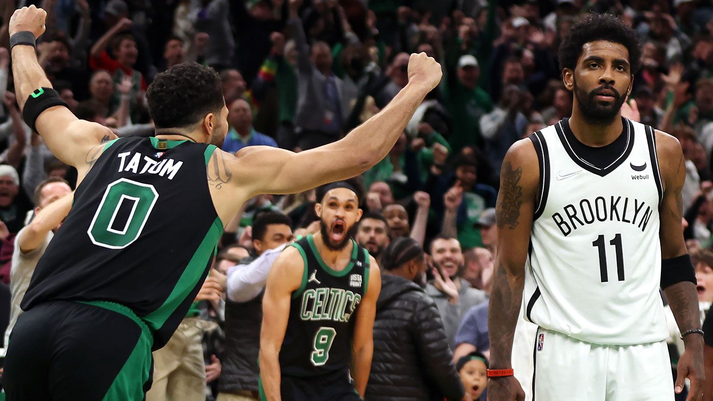  Jayson Tatum #0 of the Boston Celtics celebrates the game winning basket as Kyrie Irving #11 of the Brooklyn Nets looks on 