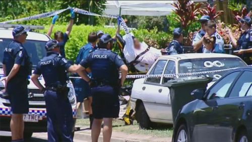 Paramedics assist a person through the police cordon. (9NEWS)