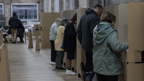 People cast their ballots during early voting for the seat of Wentworth at Oxford Street Mall on May 20, 2022 in Sydney, Australia. Independent Allegra Spender is standing for the seat of Wentworth against Liberal incumbent Dave Sharma. The Australian federal election will be held on Saturday 21 May 2022. (Photo by Brook Mitchell/Getty Images)