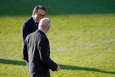 King Charles III talks to Co-Owner Wrexham AFC Ryan Reynolds (L) during their visit to Wrexham AFC on December 09, 2022 in Wrexham, Wales. 