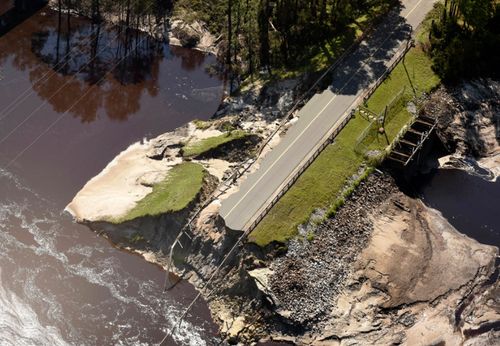 The dam and roadway at Alton Lennon Drive in Boiling Spring Lakes, North Carolina is washed away. 