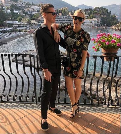 Roxy Jacenko in a dress from Dolce &amp; Gabbana and&nbsp;Gianvito Rossi heels with husband Oliver Curtis&nbsp;