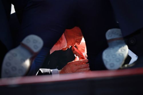 Secret Service tend to republican presidential candidate former President Donald Trump onstage.