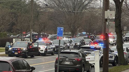 Emergency vehicles are parked outside the Abundant Life Christian School in Madison, Wis., where multiple injuries were reported following a shooting, Monday, Dec. 16, 2024. (AP Photo/Kathleen Foody)