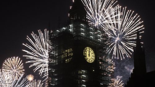 Big Ben chimed as fireworks lit up central London. (AAP)
