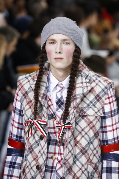 The master of tailoring sent male models down the Paris Runway with plaited
pigtails and enough makeup to make Marie Antoinette cough into her cake. &nbsp;