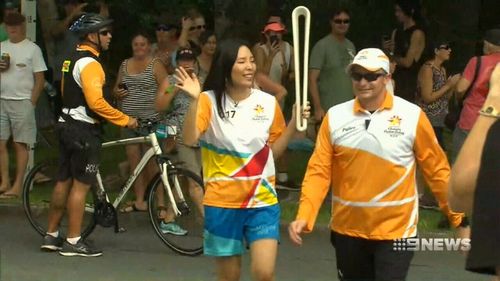 Dami Im carries the baton through her home streets. (9NEWS)