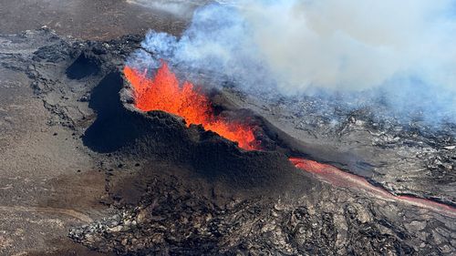 Lava spurts and flows after the eruption of a volcano in the Reykjanes Peninsula, Iceland, July 12, 2023, as seen in this handout picture taken from a Coast Guard helicopter. 