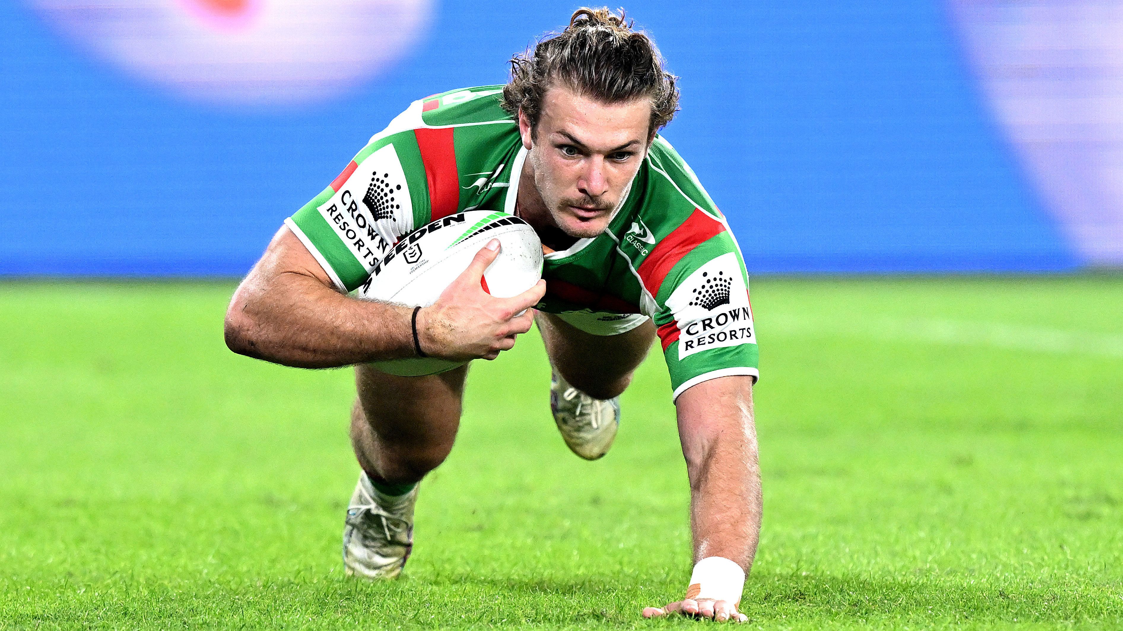 Campbell Graham of the Rabbitohs scores a try against the Broncos in round nine.