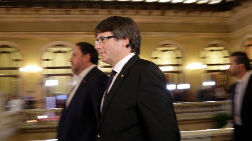 Catalan regional President Carles Puigdemont walks into the Catalan parliament. (Image: AP)