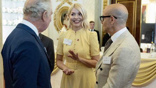 Holly Willoughby pictured with  King Charles III at Buckingham Palace in May 2023.