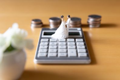 Wedding couple, calculator and coins. Money image related to wedding plan and preparation, marriage and family planning, housing and pension.
