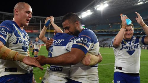 Relieved Bulldogs players after the final siren. (AAP)