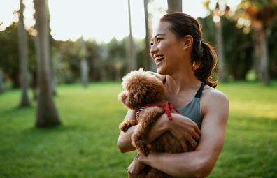 Woman outside with dog, laughing stock image