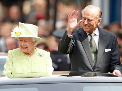 Queen Elizabeth II and Prince Philip, Duke of Edinburgh travel through Windsor in an open top Range Rover after her 90th Birthday Walkabout on April 21, 2016 in Windsor, England. 