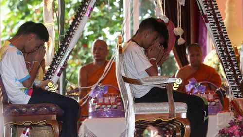 Members of the rescued soccer team attend a Buddhist ceremony that is believed to extend the lives of its attendees as well as ridding them of dangers and misfortunes in Mae Sai district, Chiang Rai province, northern Thailand. (Image: AP)