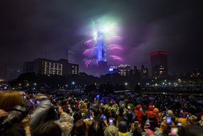 Fireworks and light effects illuminate the night sky from the Taipei 101 skyscraper during New Year's Eve celebrations in Taipei, Taiwan.