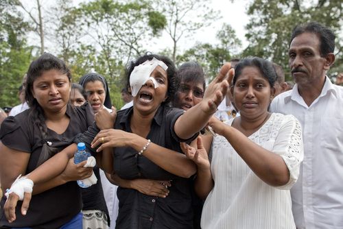 A grieving widow mourns her family who were killed when e=several blasts went off at churches and hotels around Sri Lanka on Easter Sunday.