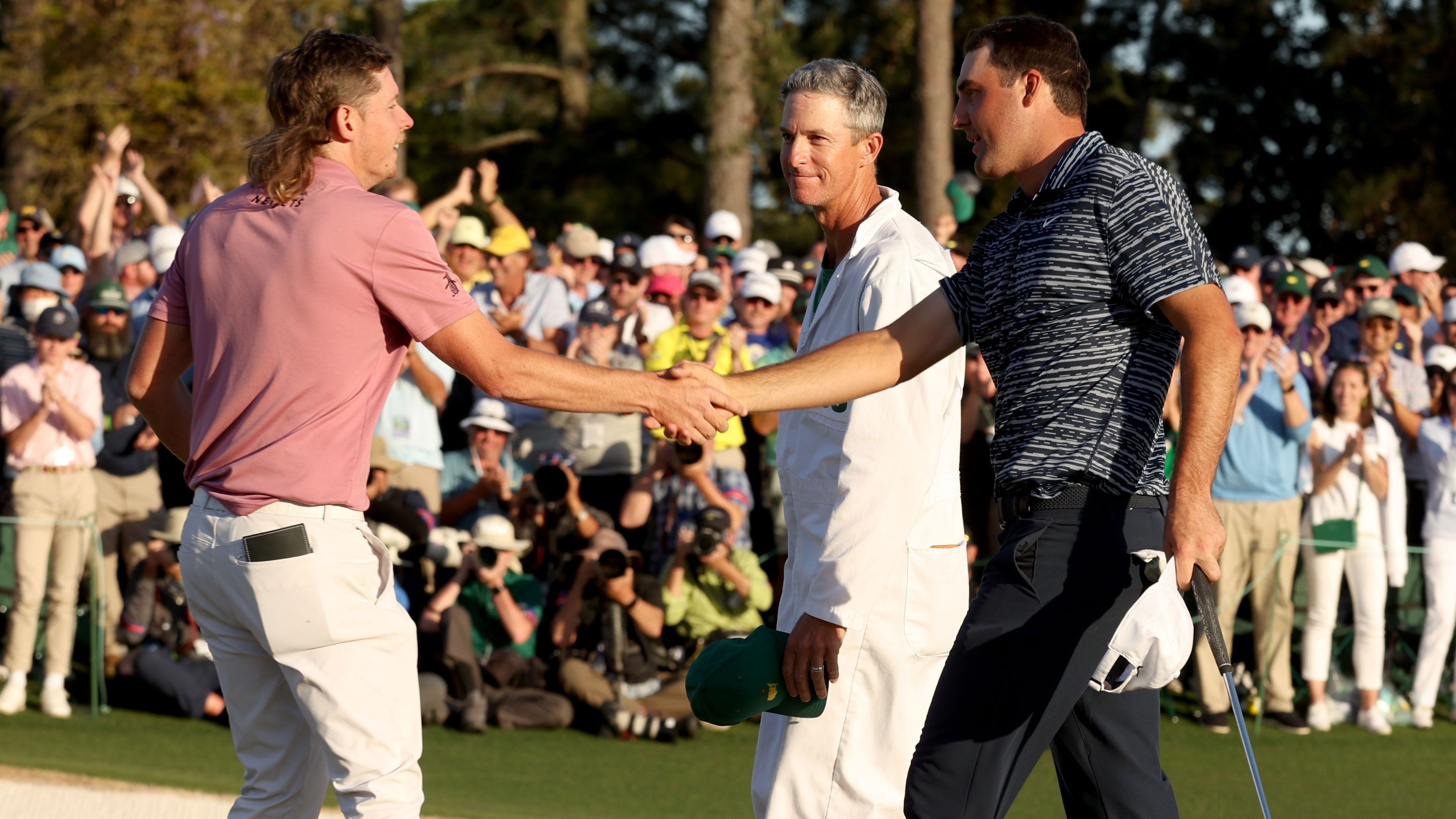 Cameron Smith of Australia (L) and Scottie Scheffler shake hands on the 18th green after Scheffler won the Masters at Augusta National.