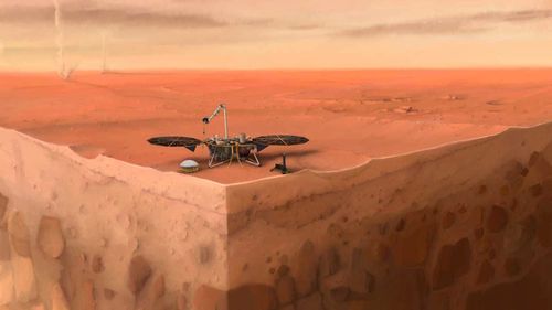 Dans le concept de cet artiste de l'atterrisseur InSight de la NASA sur Mars, des couches du sous-sol de la planète peuvent être vues ci-dessous et des diables de poussière peuvent être vus en arrière-plan.