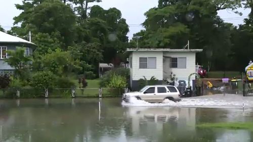 A driver in floodwaters in Mossman, north of Port Douglas. (9NEWS)