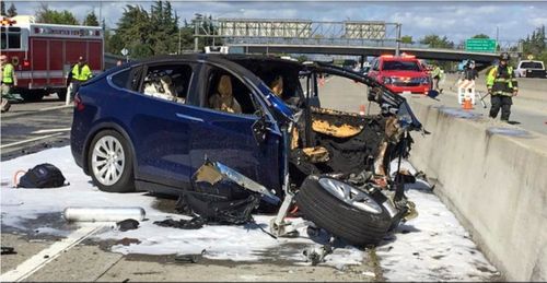 Emergency personnel work a the scene where a Tesla electric SUV crashed into a barrier on U.S. Highway 101 in California.