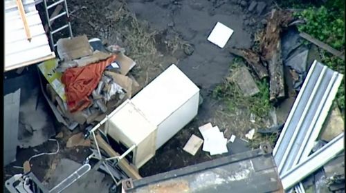 The workers were clearing out old self-storage units when they found a wheelie bin with a boot inside, connected to human remains. Picture: 9NEWS.