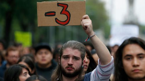 A man protests following the disappearance of three film students from the Mexican city of Guadalajara.