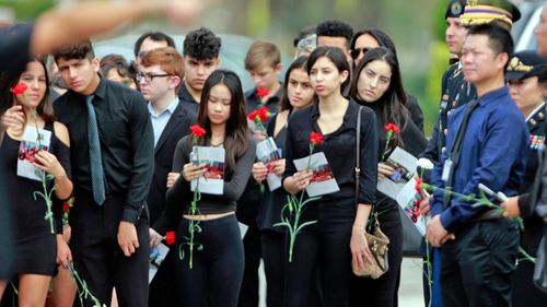 Mourners attend the funeral of Peter Wang/ (Photo: AP).