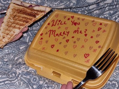 Marriage proposal written on takeaway food container