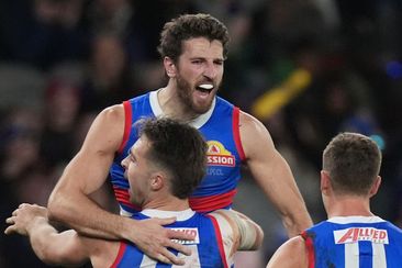 Western Bulldogs and Fremantle Dockers; Marcus Bontempelli celebrates kicking a goal.