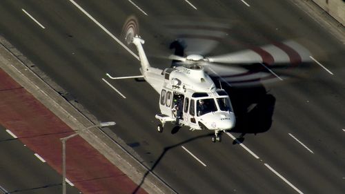Rescue helicopter lands on Sydney Harbour Bridge after a fatal multi-vehicle crash. August 27, 2020.
